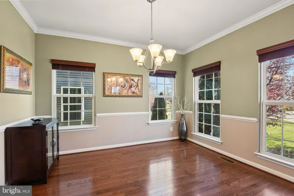 a view of a dining room with wooden floor