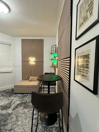 a view of a bedroom with furniture and window
