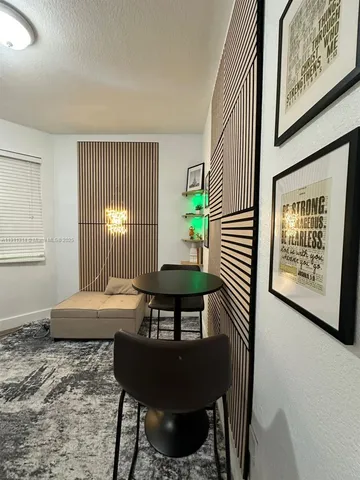 a view of a bedroom with furniture and window