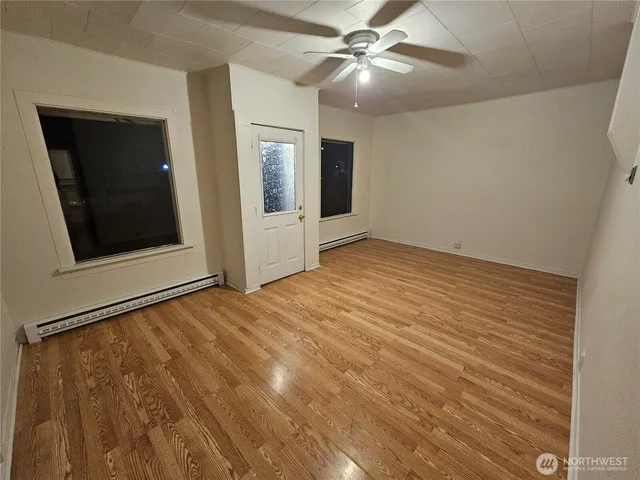 a view of an empty room with closet and a chandelier fan
