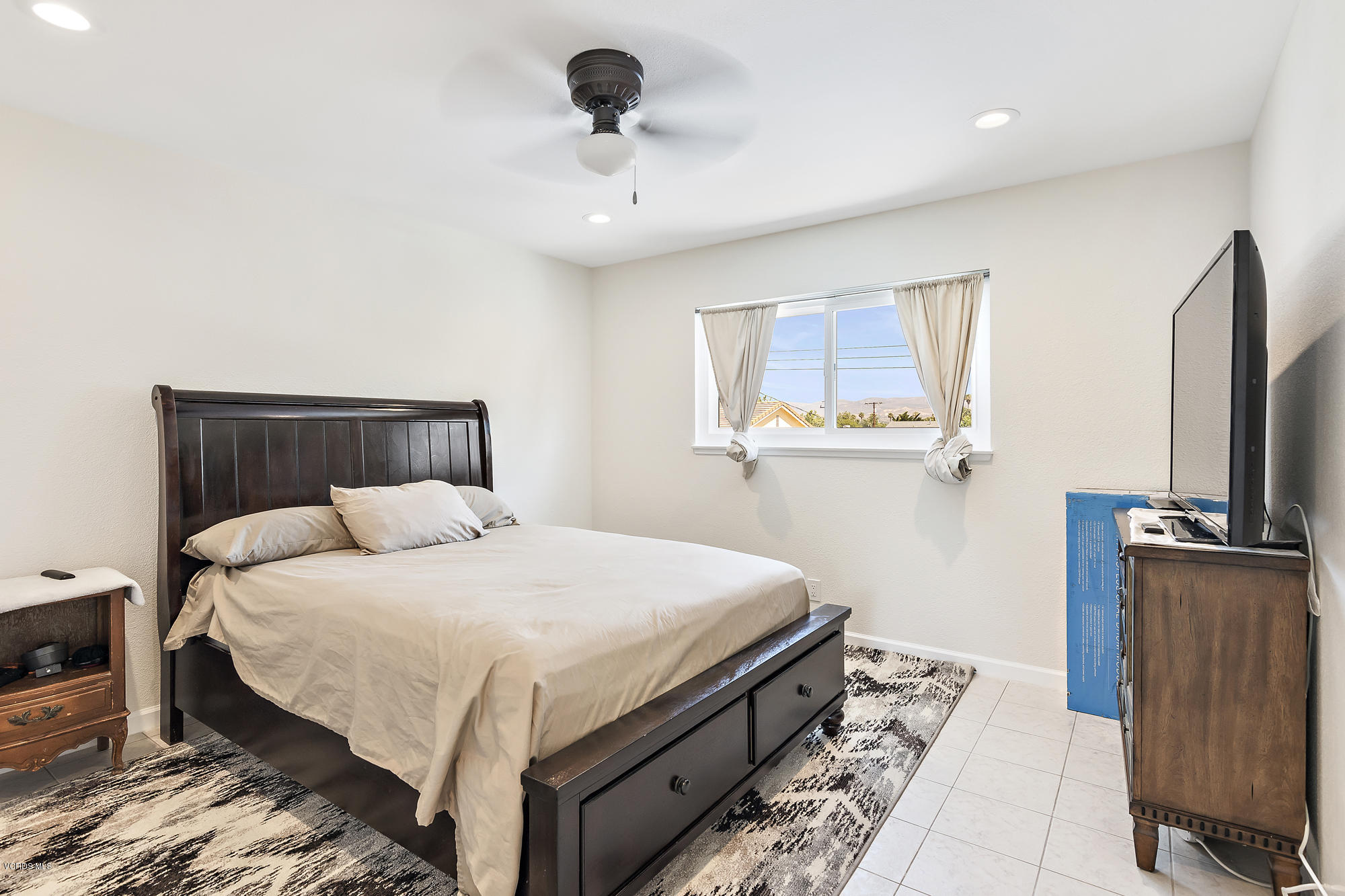 2551 Fitzgerald Road Simi Valley, CA 93065 - Photo 11 of 17 a bedroom with a bed and a flat screen tv