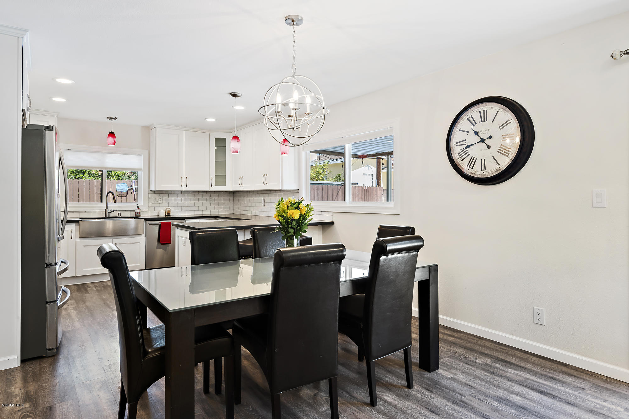 2551 Fitzgerald Road Simi Valley, CA 93065 - Photo 7 of 17 a dining room with wooden floor a chandelier a wooden table and chairs