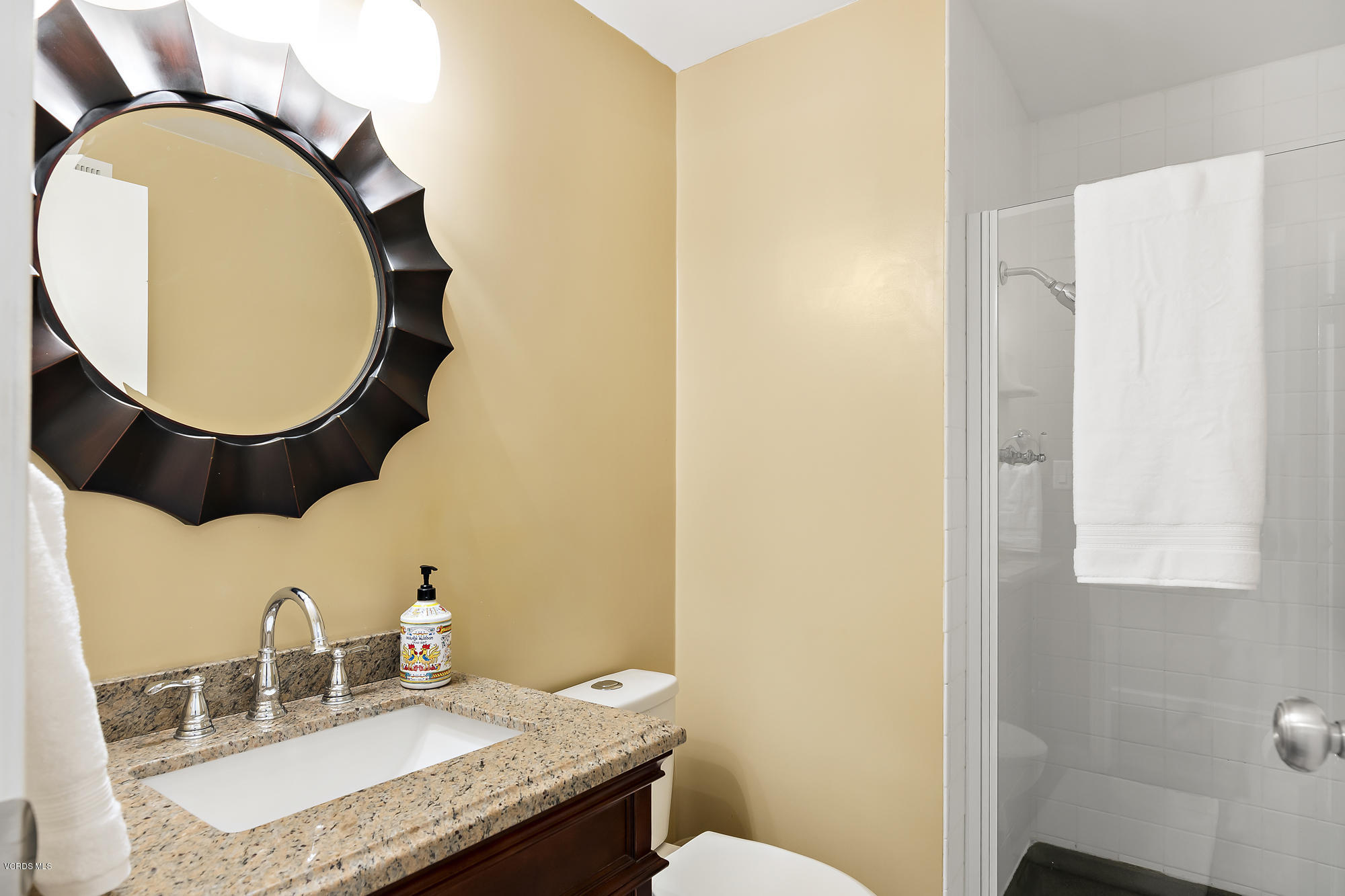 2551 Fitzgerald Road Simi Valley, CA 93065 - Photo 10 of 17 a bathroom with a granite countertop double vanity and a mirror