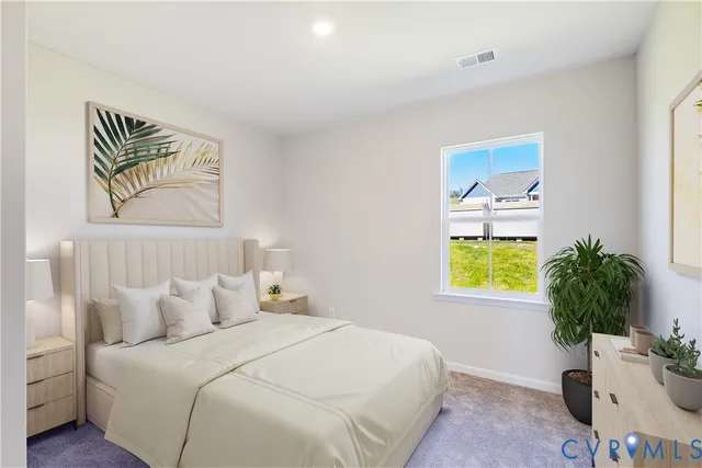 a bedroom with a bed and a potted plant