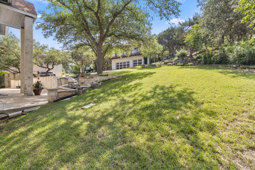 10800 Beach Road Leander, TX 78641 - Photo 4 of 39 Mature trees provide ample shade across this expansive, naturally illuminated yard, offering a tranquil retreat.