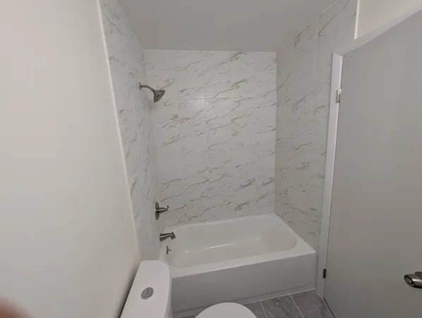 a bathroom with a bathtub and a shower
