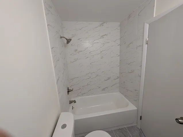 a bathroom with a bathtub and a shower