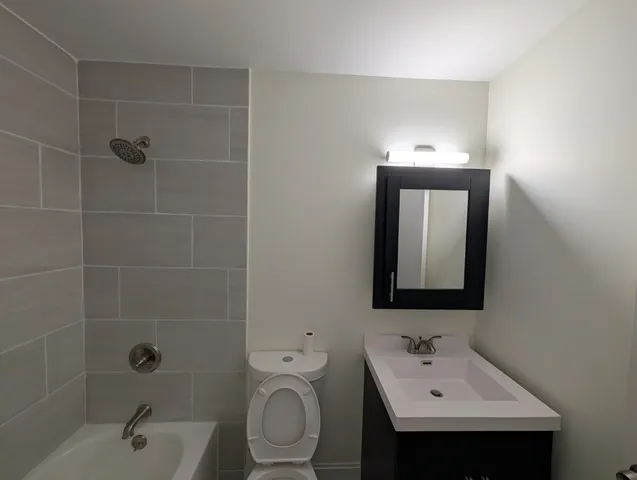 a bathroom with a toilet sink shower and mirror