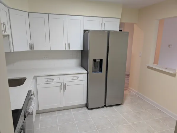a kitchen with cabinets and stainless steel appliances