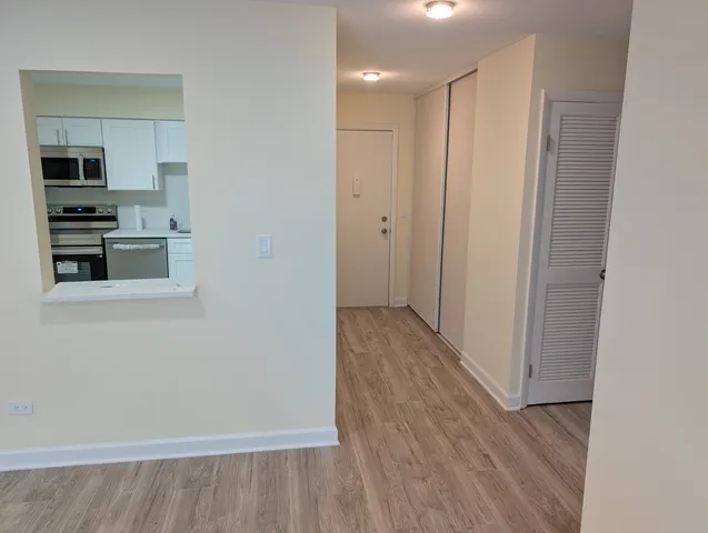 a view of a hallway with wooden floor