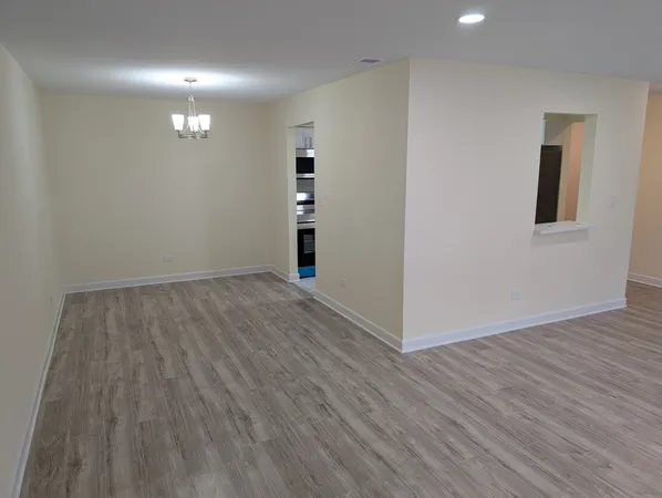 a view of hallway with wooden floor