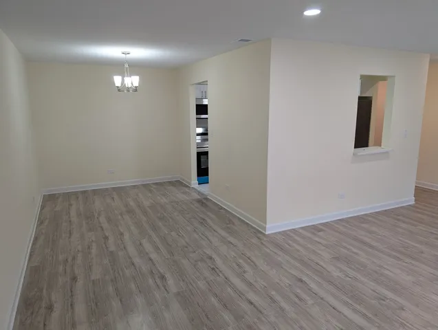 a view of hallway with wooden floor