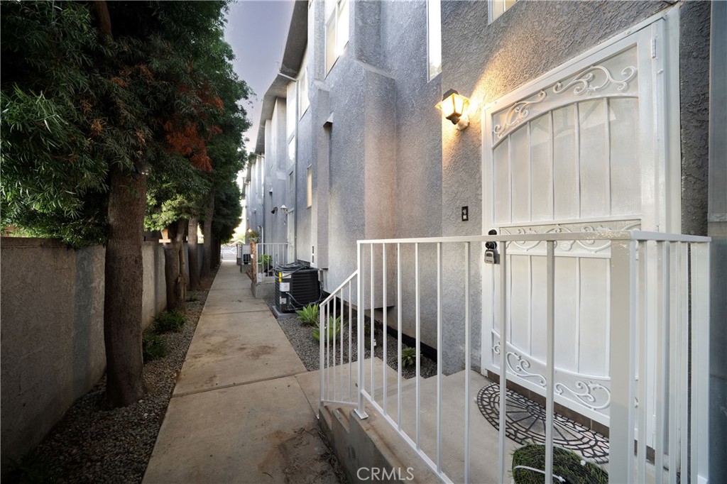 a view of a house with a wooden fence
