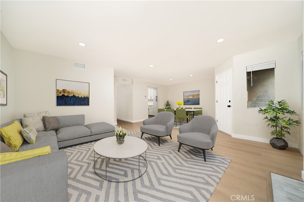1067 252nd Street, Unit 7 Harbor City, CA 90710 - Photo 1 of 23 a living room with furniture potted plant and a window