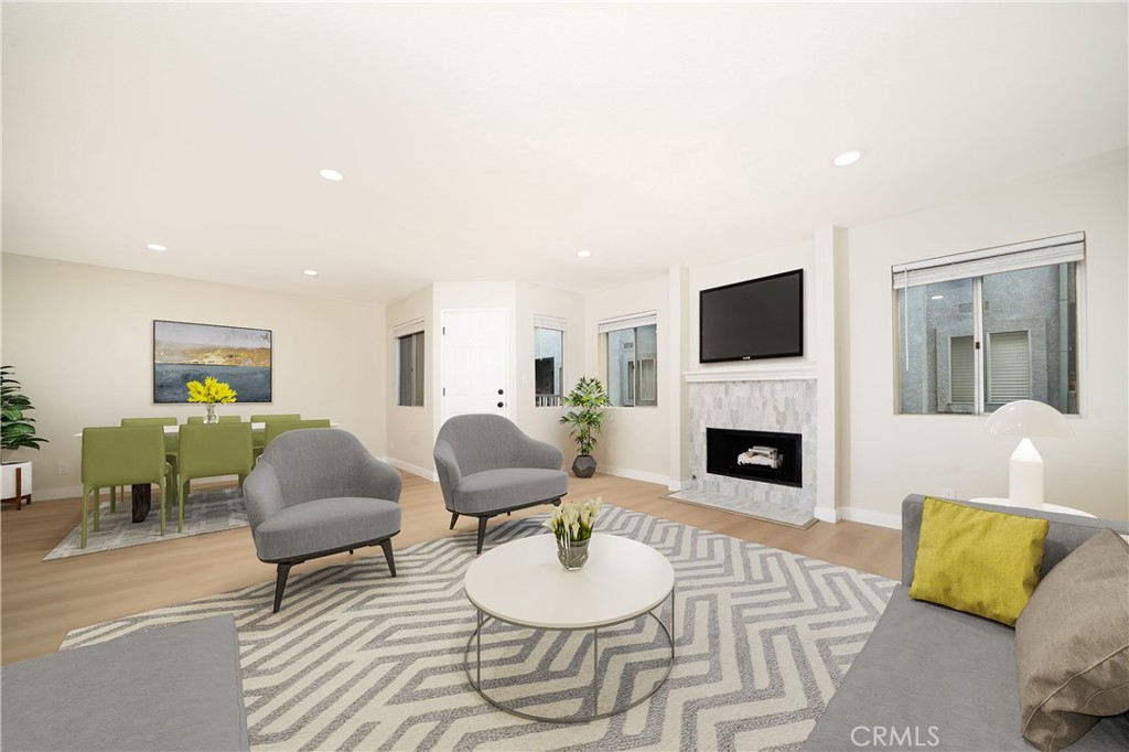 1067 252nd Street, Unit 7 Harbor City, CA 90710 - Photo 4 of 23 a living room with furniture fireplace and a flat screen tv