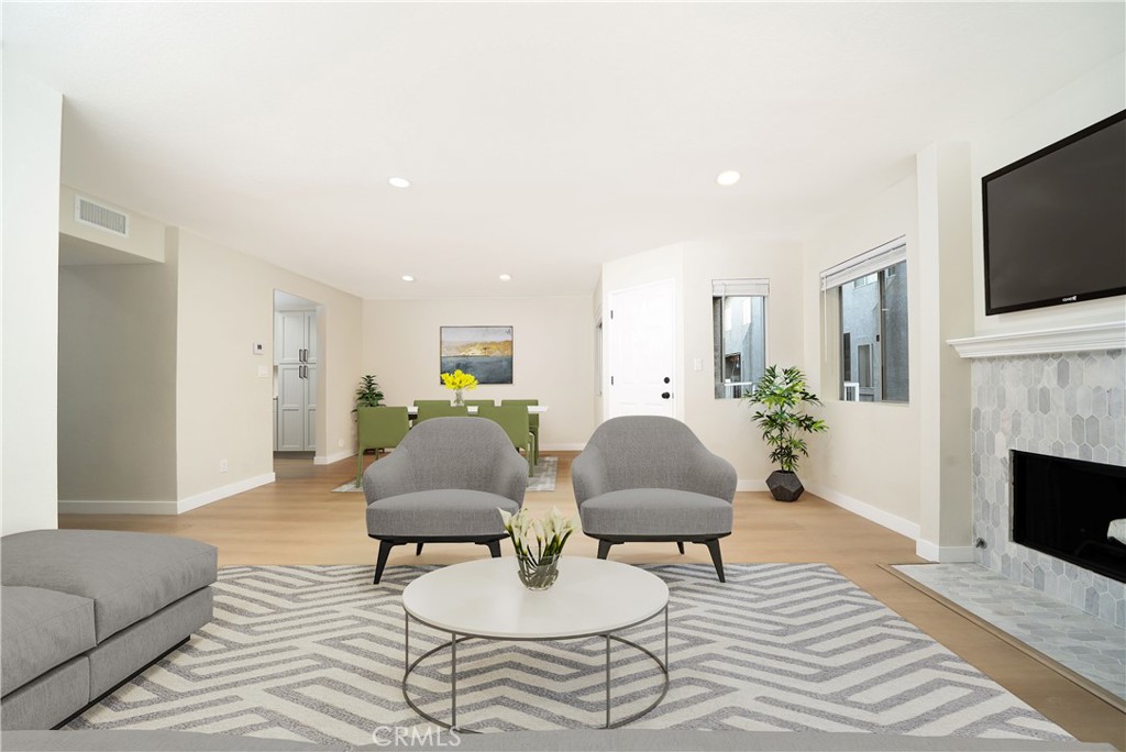 1067 252nd Street, Unit 7 Harbor City, CA 90710 - Photo 5 of 23 a living room with furniture fireplace and flat screen tv