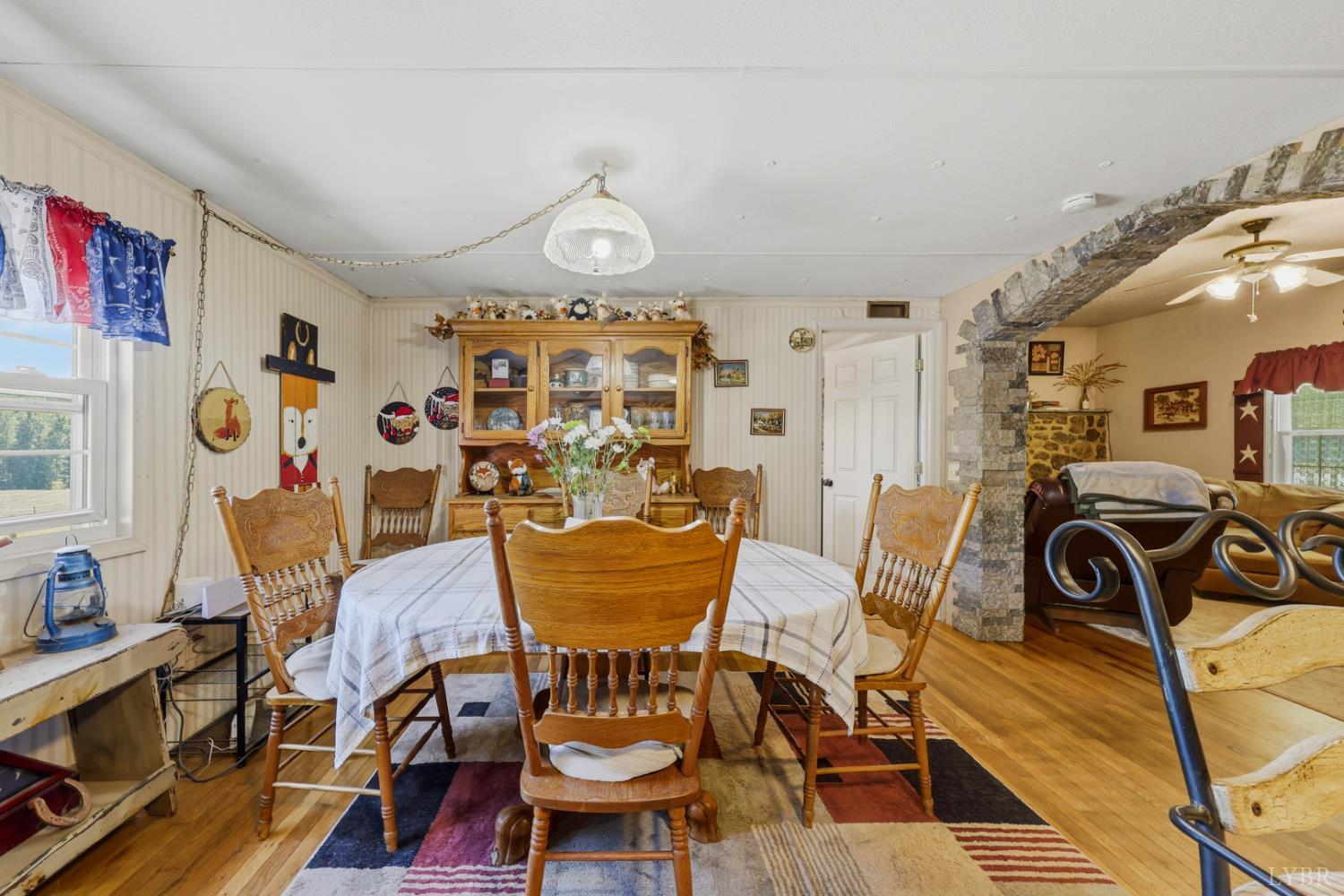 809 Plantation Road Amherst, VA 24521 - Photo 19 of 77 a view of a dining room with furniture a chandelier and wooden floor