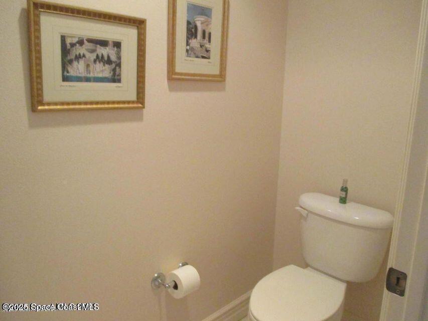 630 Cedar Side Circle Northeast Palm Bay, FL 32905 - Photo 11 of 17 a white toilet sitting next to a white wall