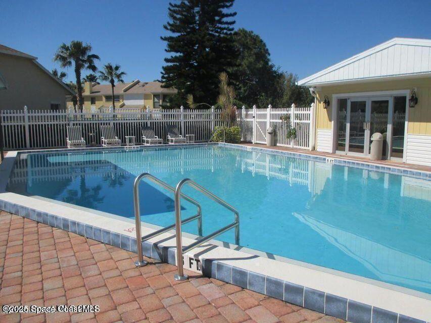 630 Cedar Side Circle Northeast Palm Bay, FL 32905 - Photo 17 of 17 a view of a swimming pool with a lounge chairs