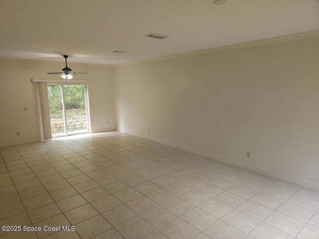 630 Cedar Side Circle Northeast Palm Bay, FL 32905 - Photo 4 of 17 an empty room with windows