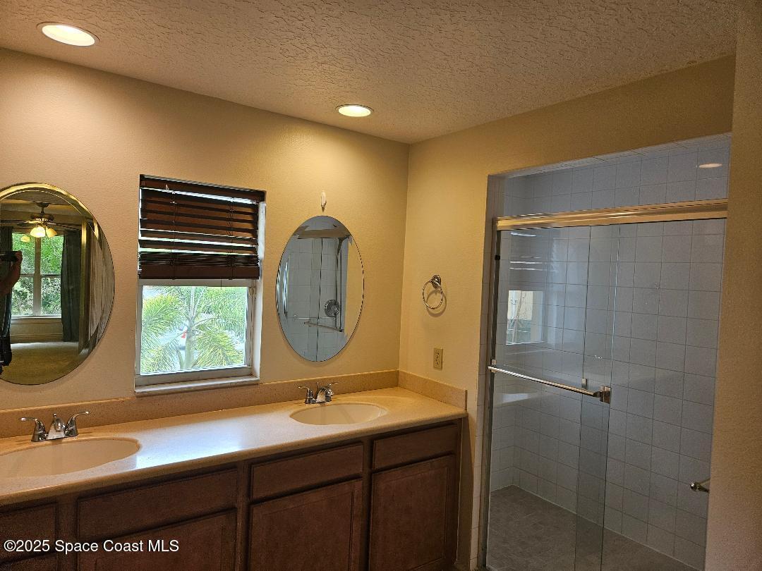 630 Cedar Side Circle Northeast Palm Bay, FL 32905 - Photo 10 of 17 a bathroom with a double vanity sink mirror and toilet