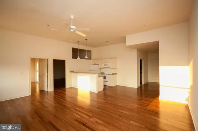 a bathroom with a granite countertop sink a toilet and a mirror