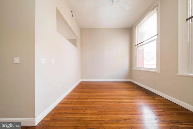 a view of a room with wooden floor