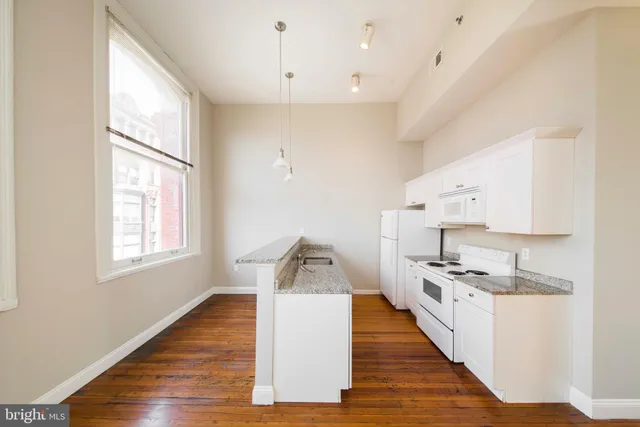 a kitchen with a stove and a sink