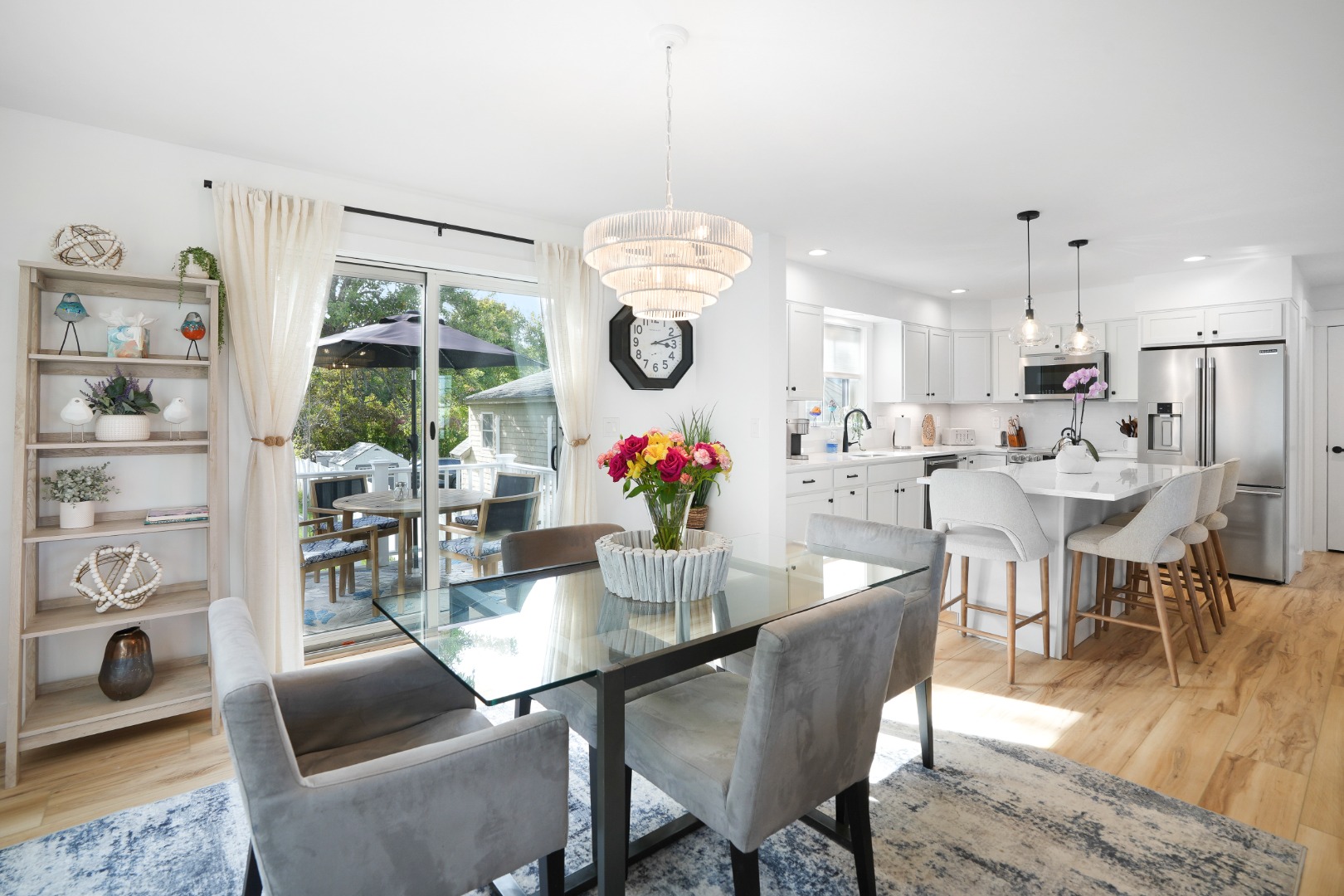 33 Lagoon Pond Road Vineyard Haven, MA 02568 - Photo 14 of 42 a dining room with stainless steel appliances a dining table and chairs with wooden floor