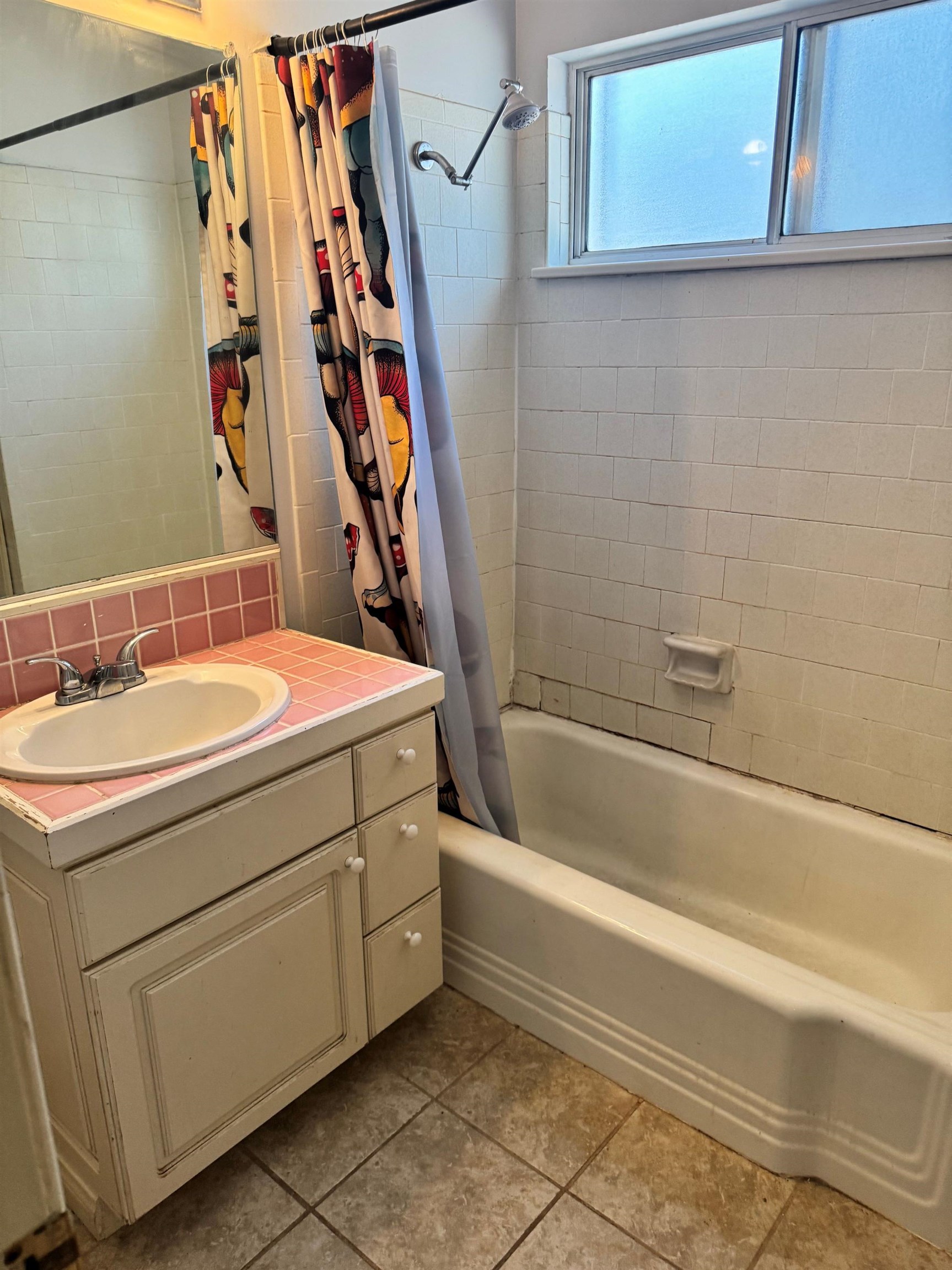 4 Kelley Road, Unit 1 Mammoth Lakes, CA 93546 - Photo 11 of 19 Bathroom featuring a white vanity with an integrated sink, pink tiled countertop, and a bath