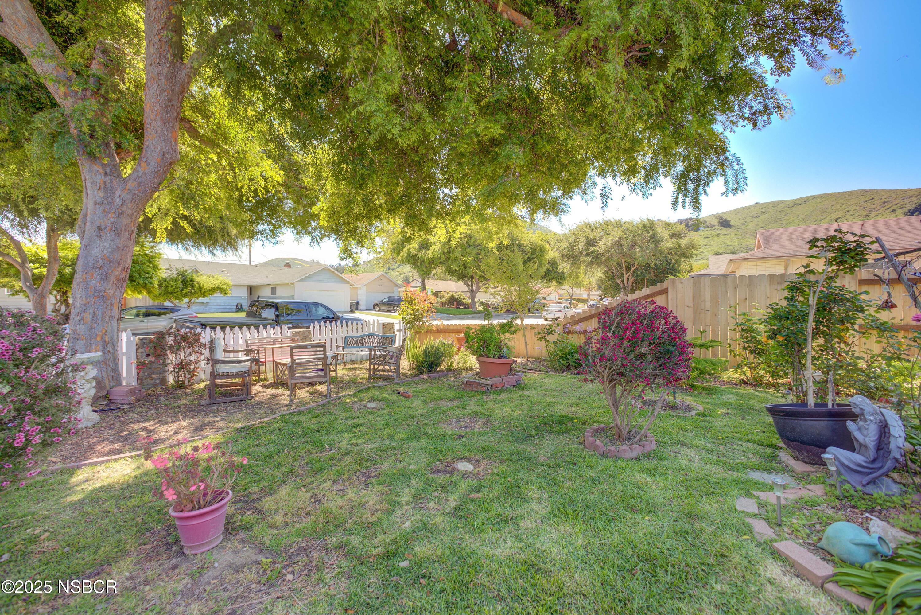 421 South O Place Lompoc, CA 93436 - Photo 12 of 12 a backyard of a house with table and chairs