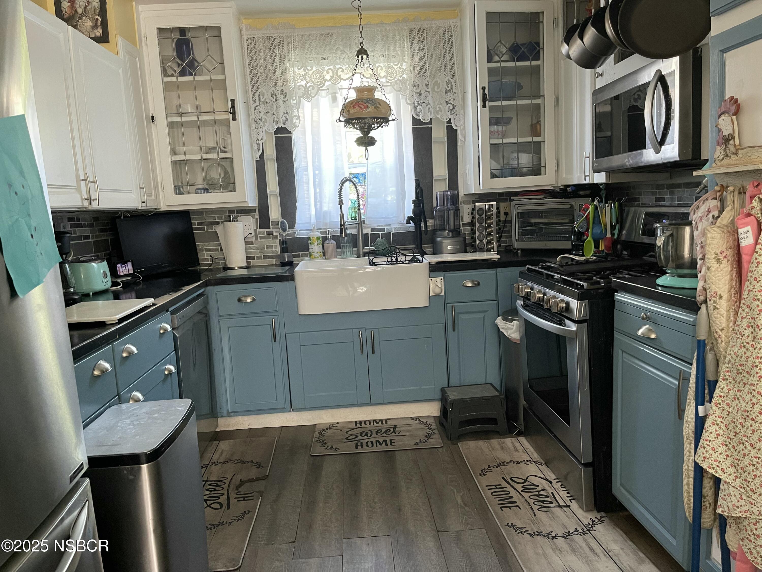 421 South O Place Lompoc, CA 93436 - Photo 2 of 12 a kitchen with stainless steel appliances granite countertop a sink stove and cabinets