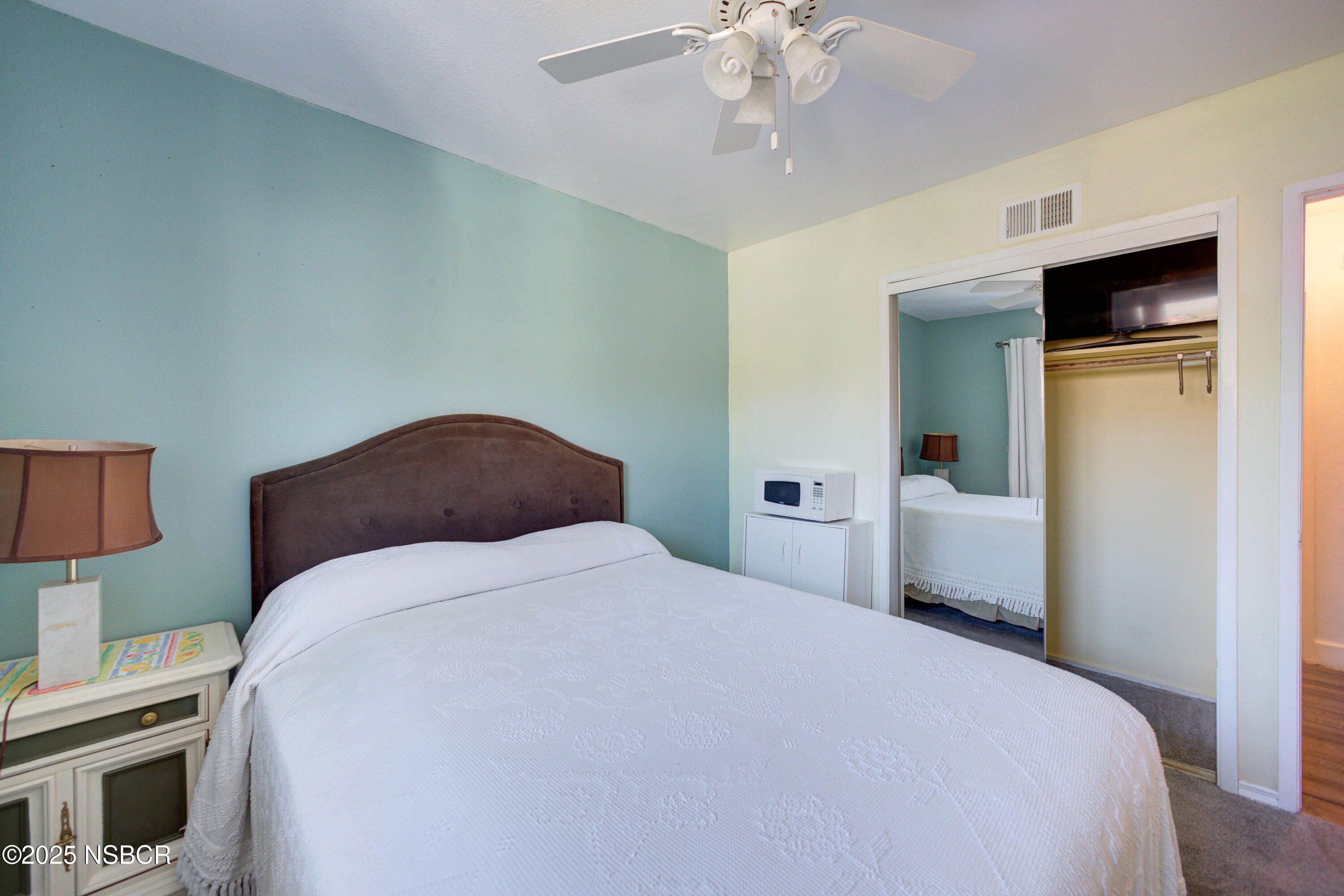 421 South O Place Lompoc, CA 93436 - Photo 7 of 12 a bedroom with a bed and a chandelier