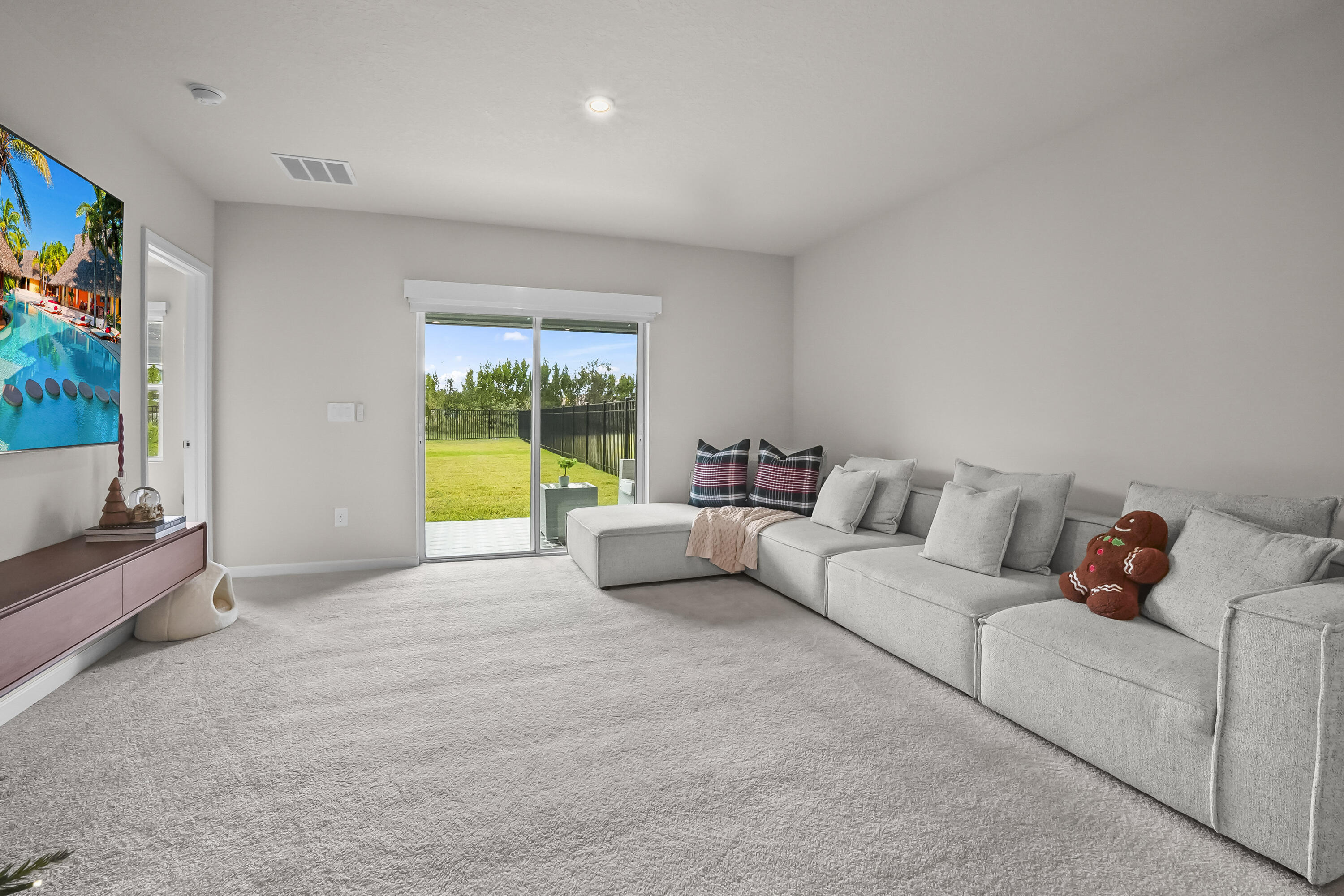 309 Raspberry Road Fort Pierce, FL 34981 - Photo 11 of 38 a living room with furniture and a flat screen tv