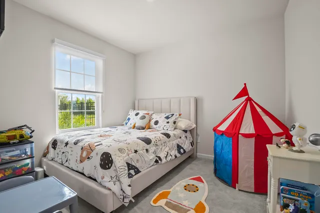 a bedroom with bed and windows