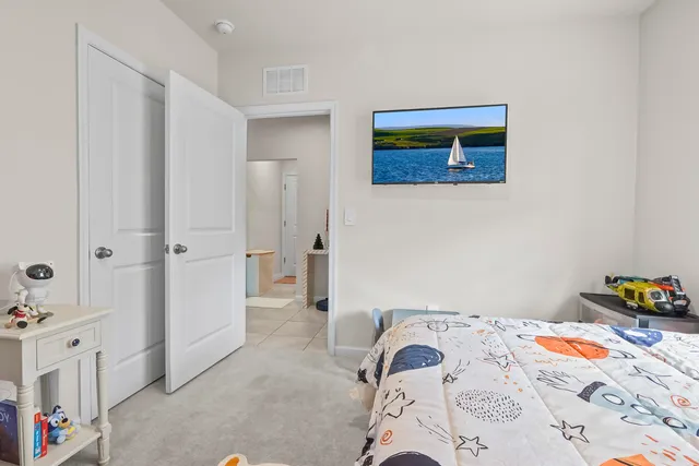 a bedroom with a bed and a dresser