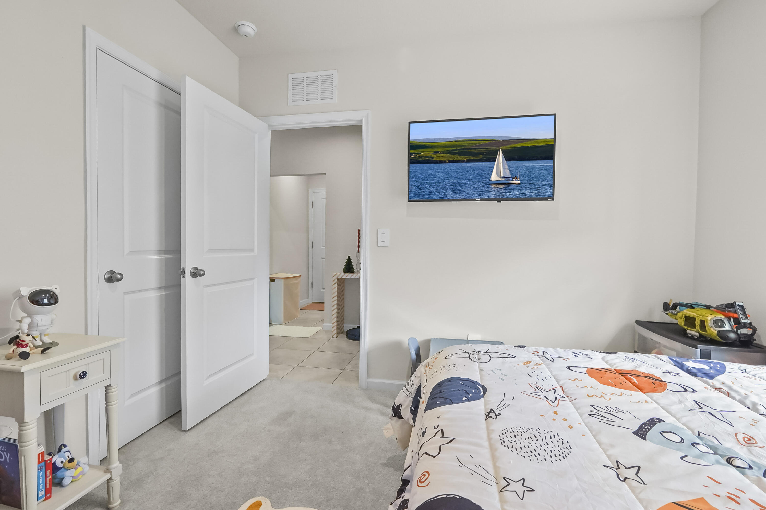 309 Raspberry Road Fort Pierce, FL 34981 - Photo 18 of 38 a bedroom with a bed and a dresser