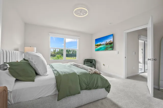 a bedroom with a bed and a window