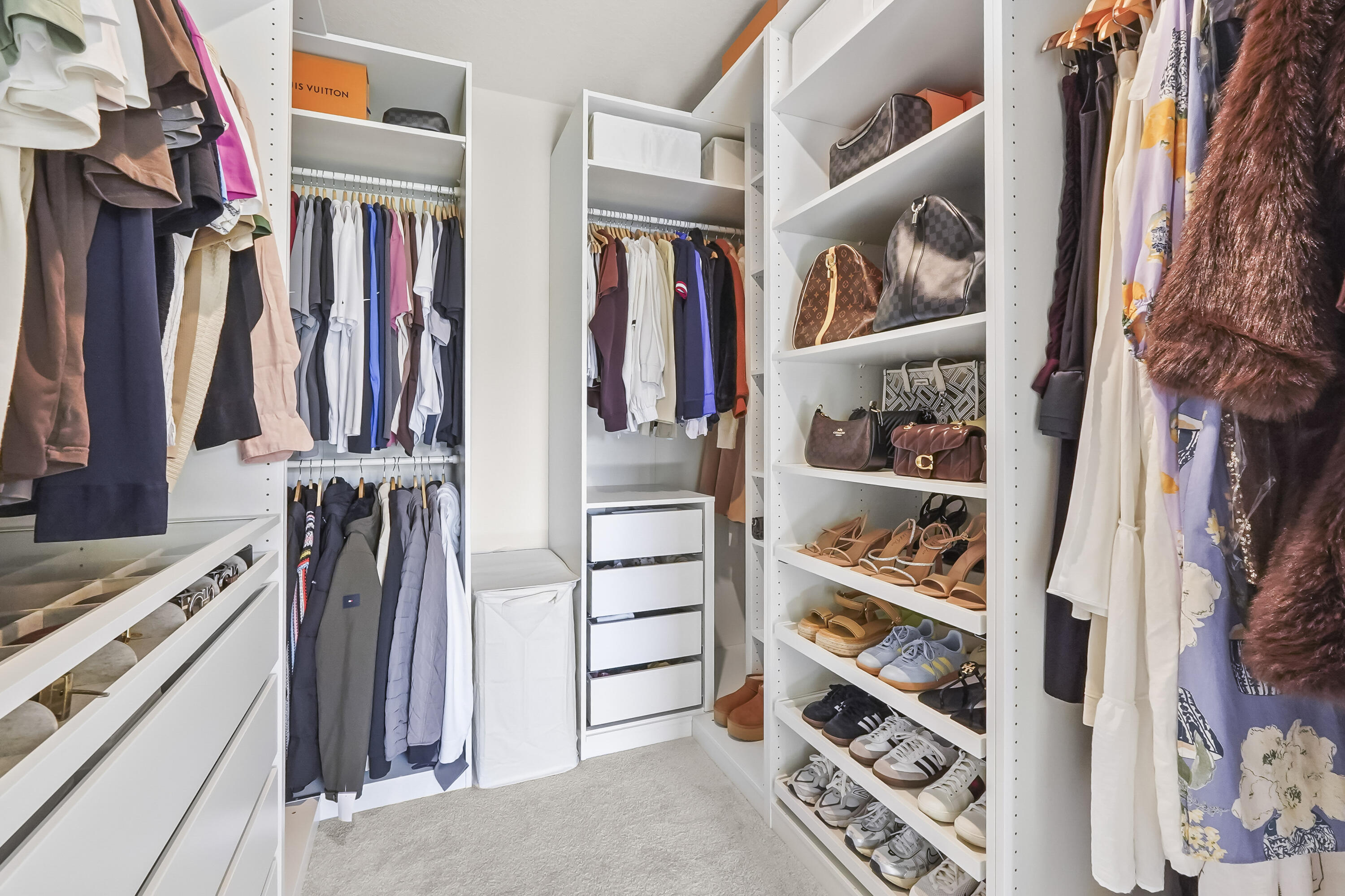 309 Raspberry Road Fort Pierce, FL 34981 - Photo 25 of 38 a view of walk in closet with clothes and shoes