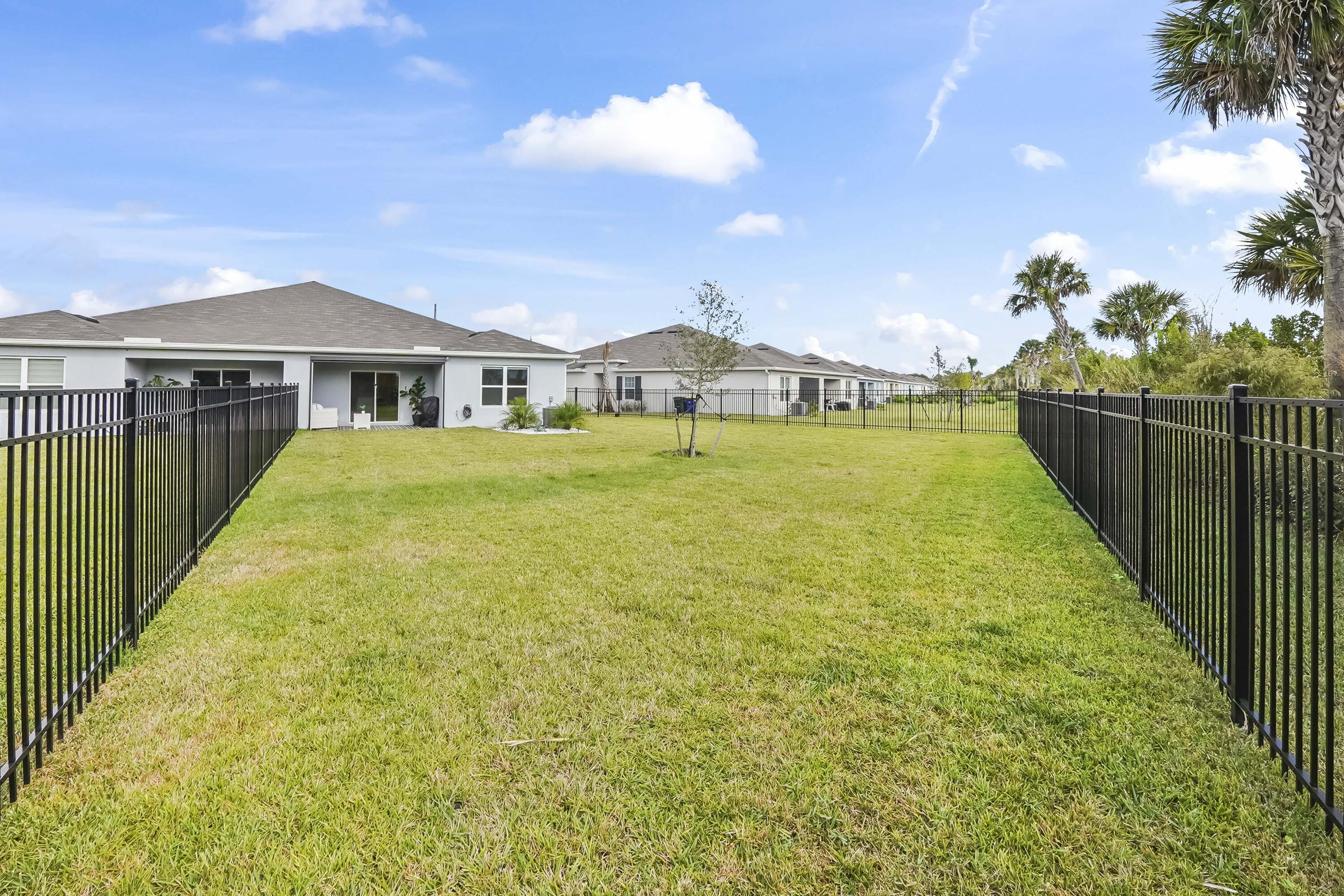 309 Raspberry Road Fort Pierce, FL 34981 - Photo 31 of 38 a front view of a house with a yard