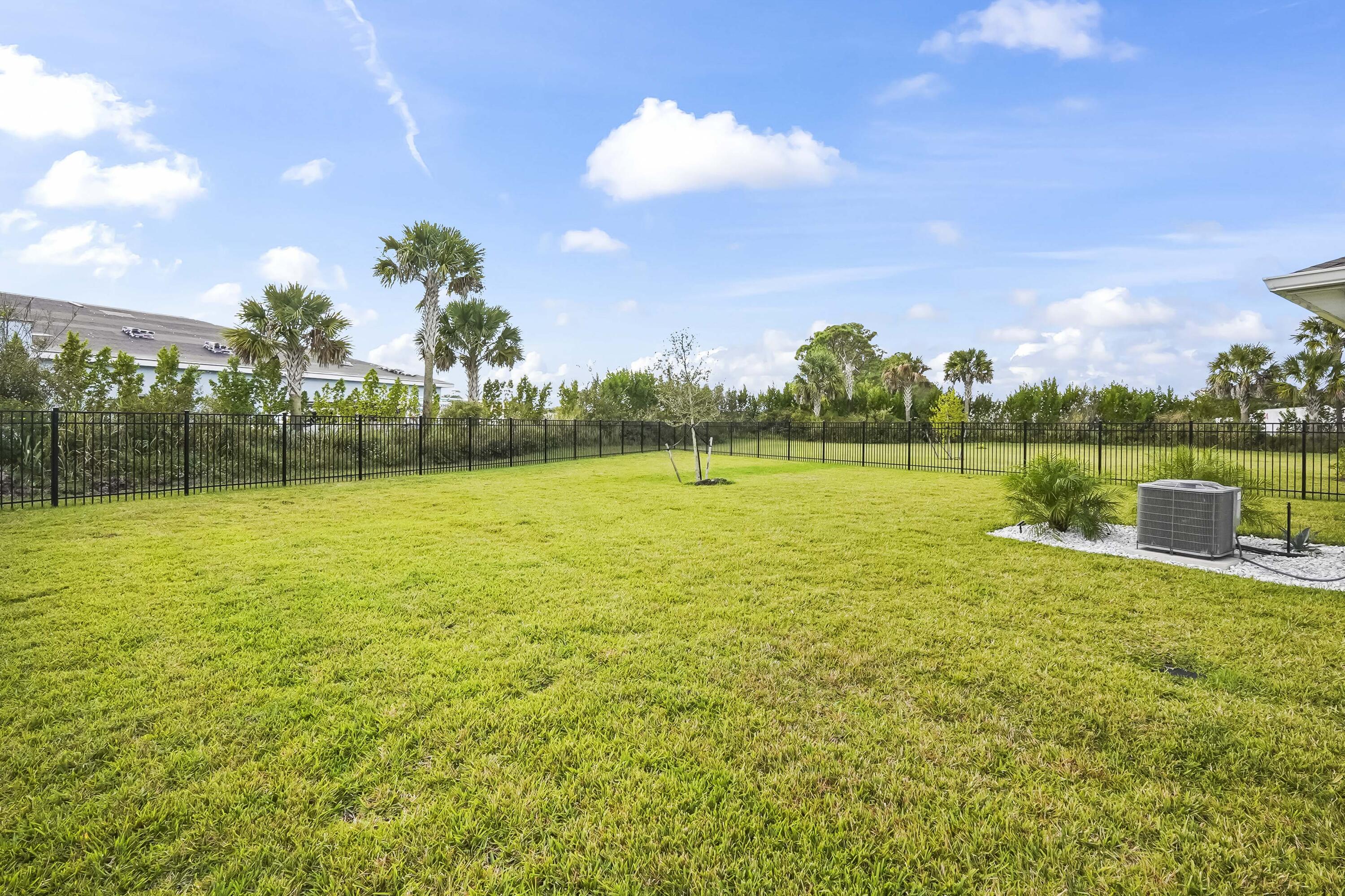 309 Raspberry Road Fort Pierce, FL 34981 - Photo 34 of 38 a view of a swimming pool with an outdoor space and seating area