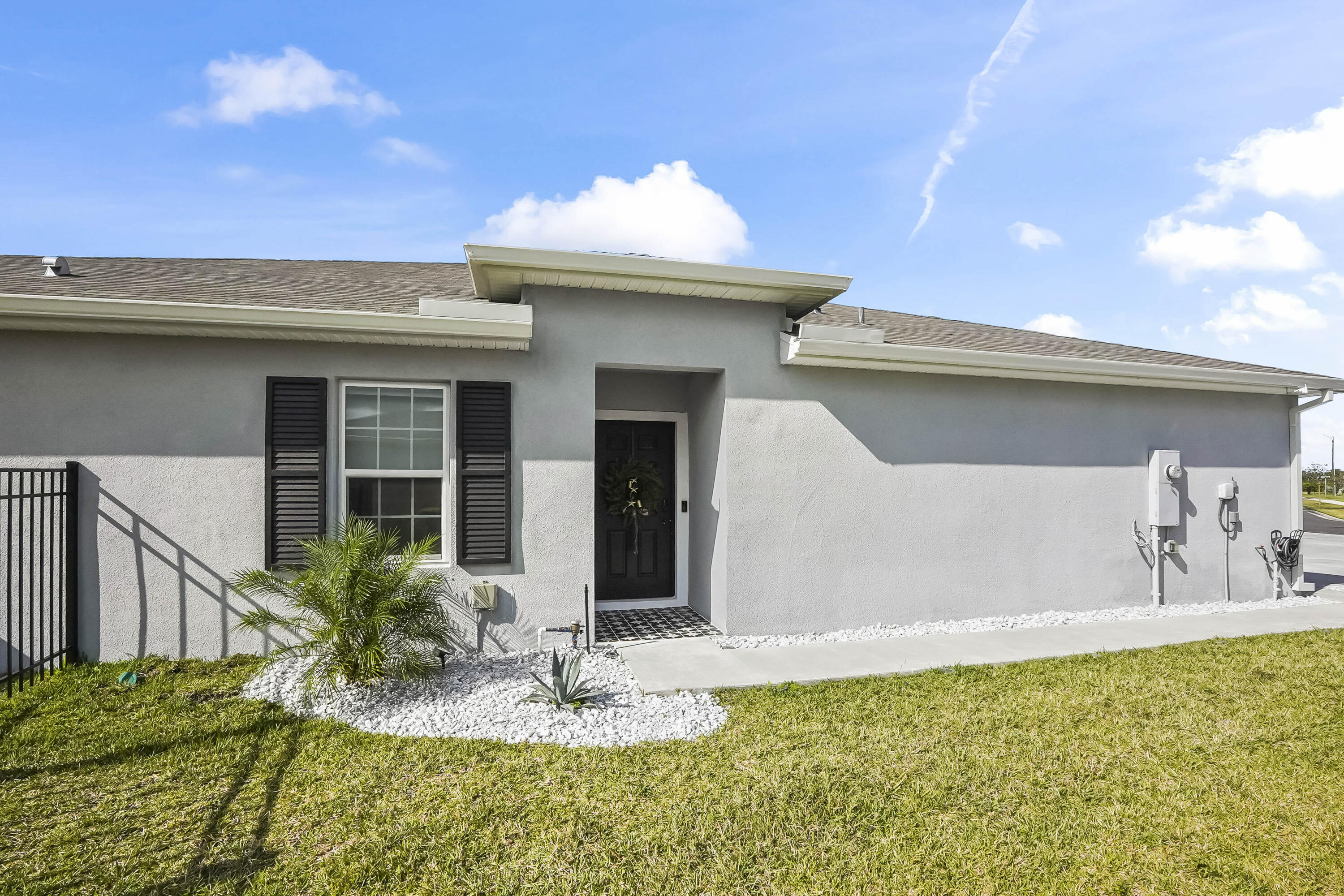 309 Raspberry Road Fort Pierce, FL 34981 - Photo 4 of 38 a view of a house with a swimming pool