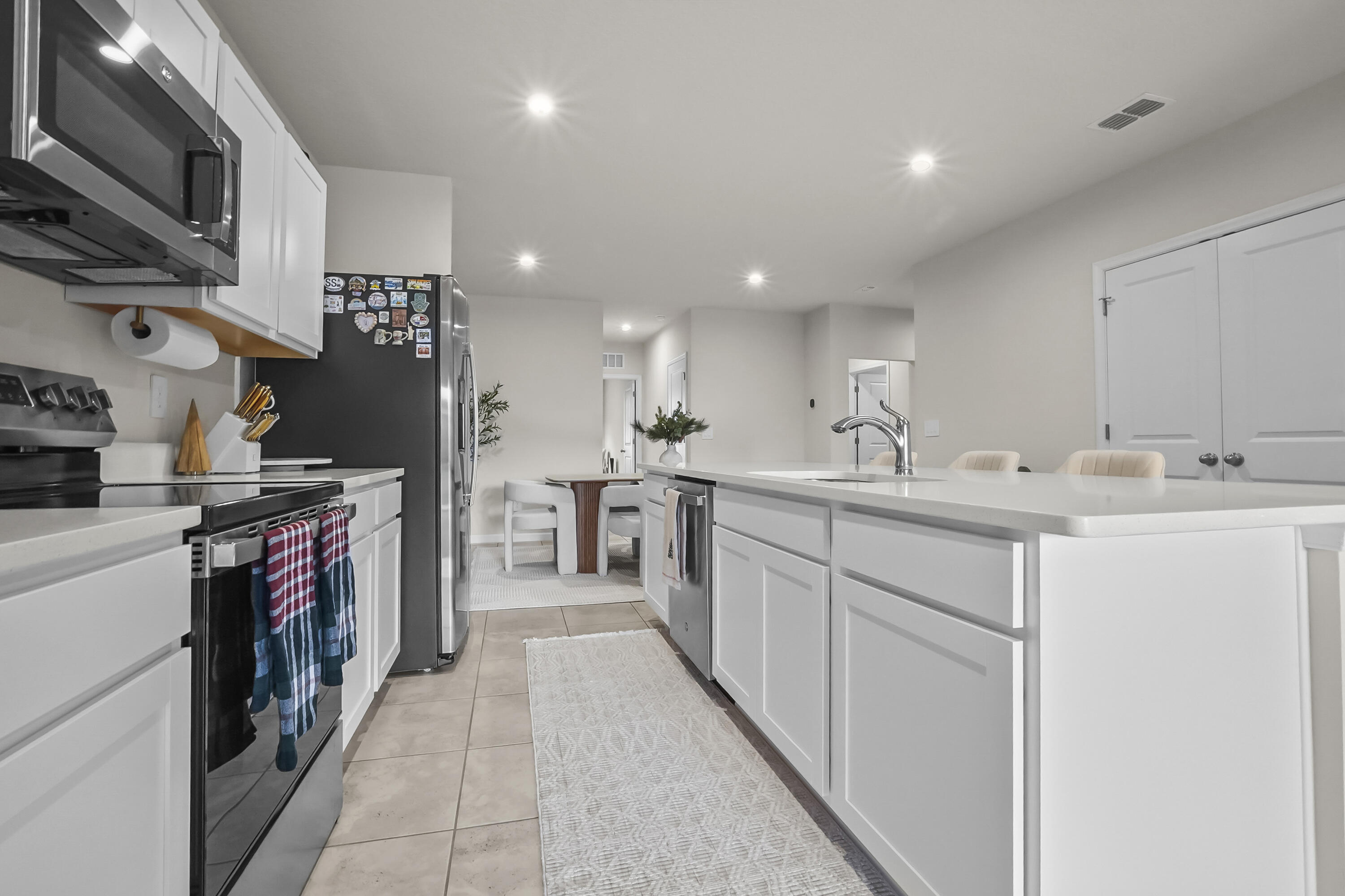 309 Raspberry Road Fort Pierce, FL 34981 - Photo 9 of 38 a kitchen with a sink appliances and cabinets