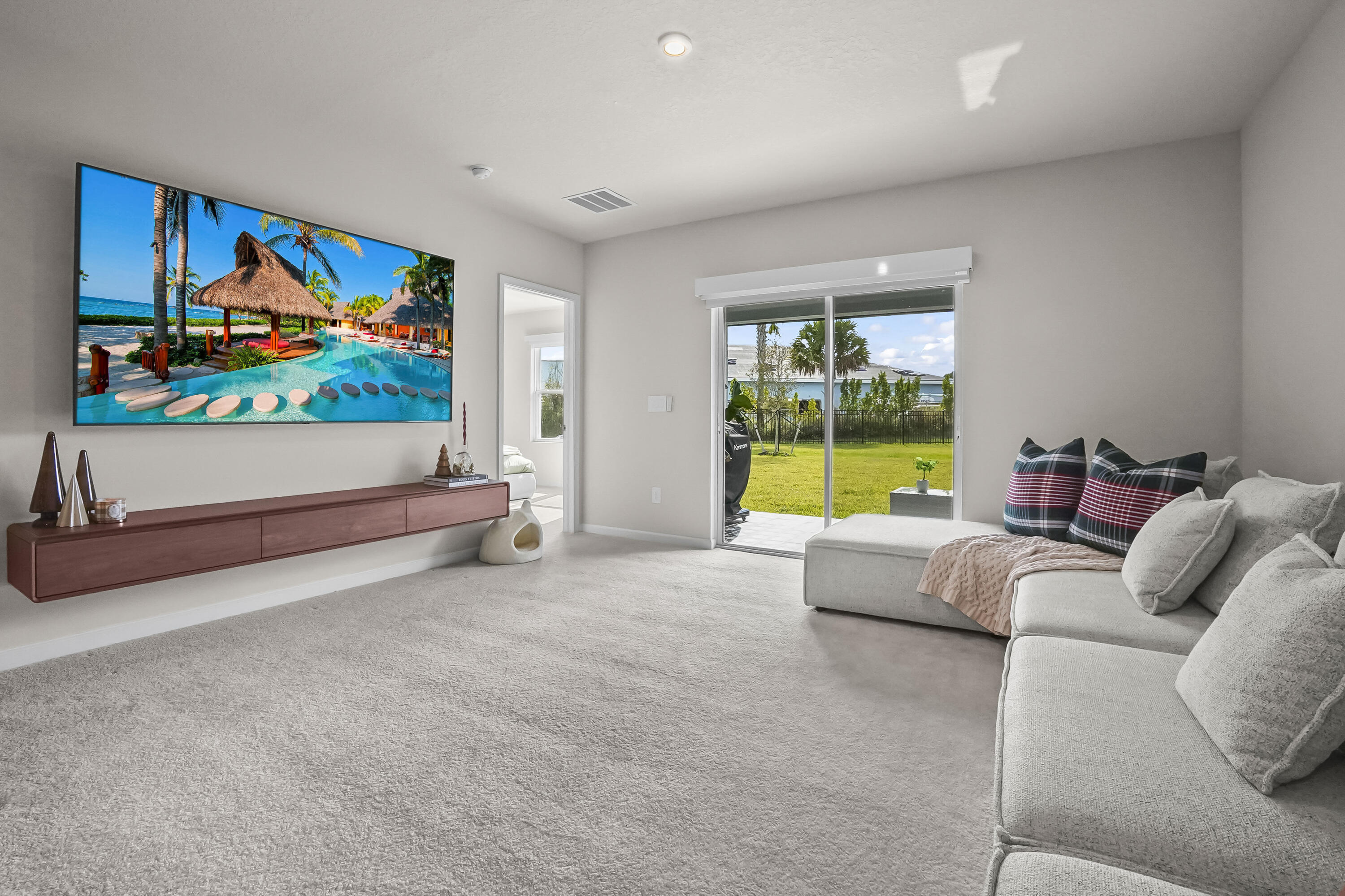 309 Raspberry Road Fort Pierce, FL 34981 - Photo 10 of 38 a living room with furniture and a flat screen tv