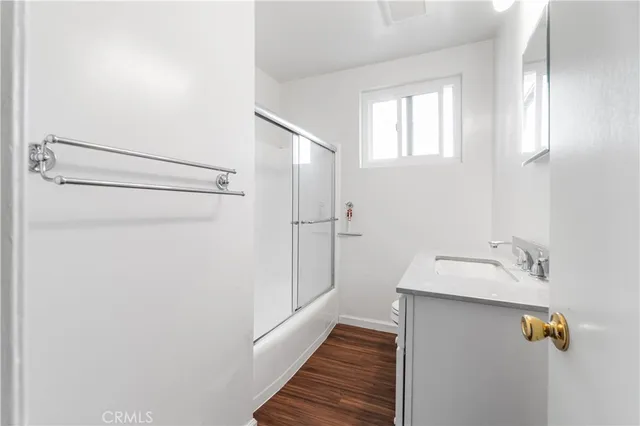 a bathroom with a shower and a sink