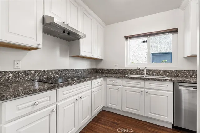 a kitchen with white cabinets and a sink