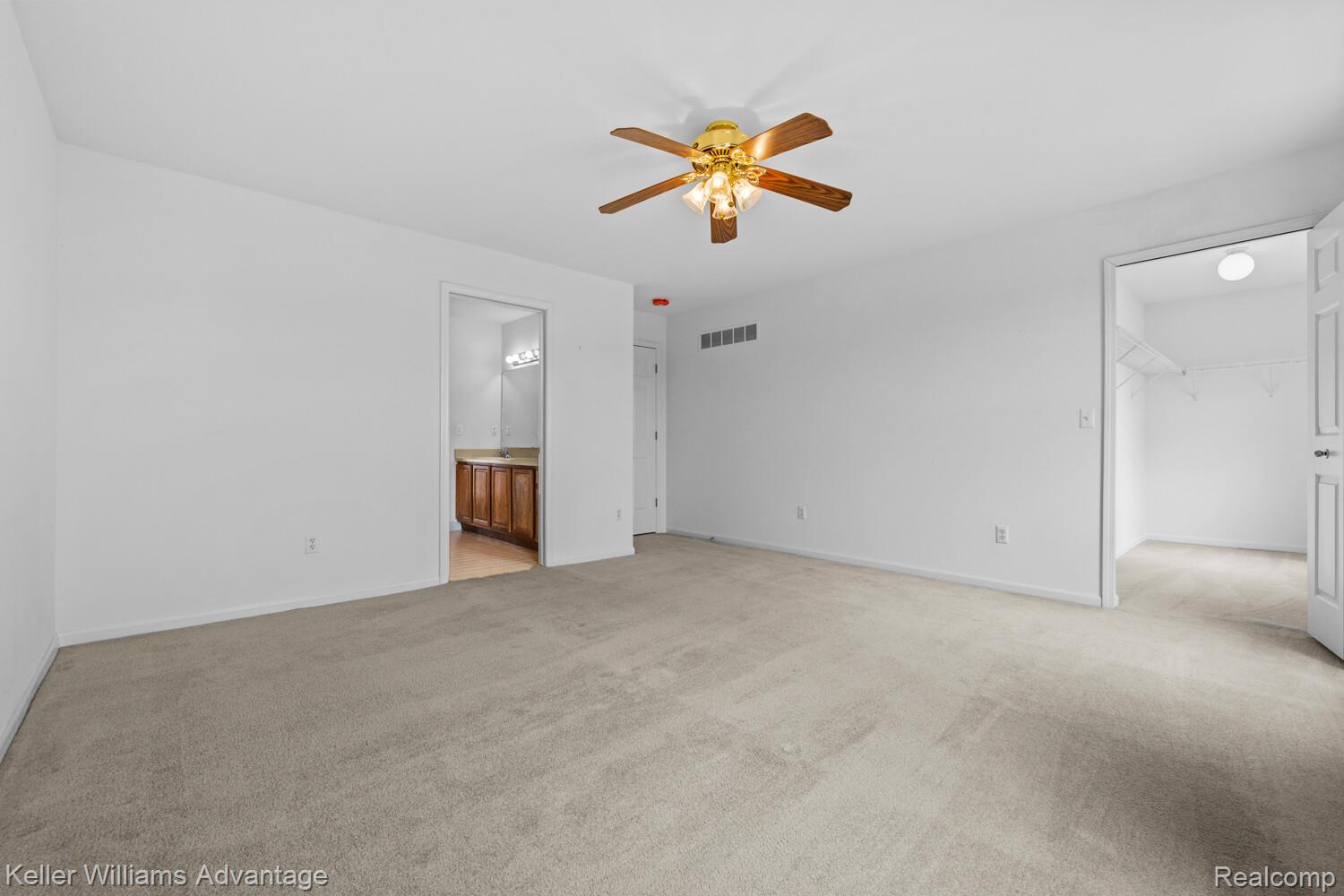 4100 Norwich Court Rochester, MI 48306 - Photo 43 of 72 Unfurnished bedroom with a walk in closet, light carpet, a ceiling fan, and connected bathroom