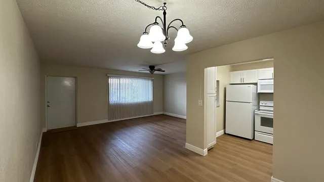a view of a room with wooden floor and window