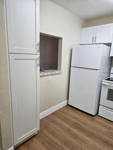 a view of a kitchen with a refrigerator