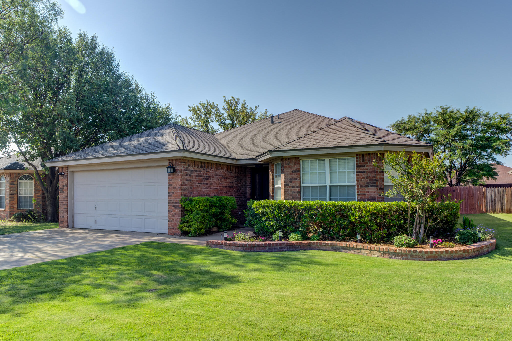 5813 88th Place Lubbock, TX 79424 - Photo 1 of 30 a front view of a house with a yard and garage